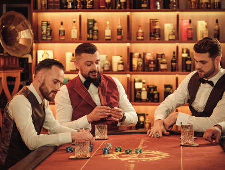 Group of upper class men playing poker in gentlemens clubの写真素材