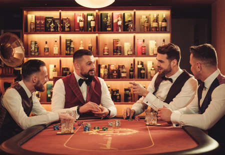Group of upper class men playing poker in gentlemens clubの写真素材