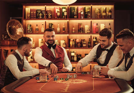 Group of upper class men playing poker in gentlemens clubの写真素材