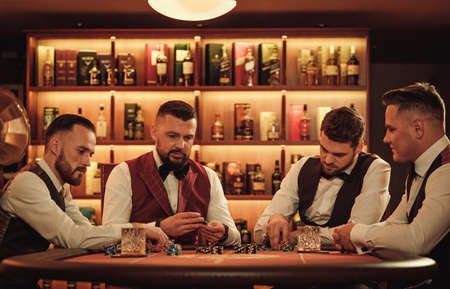 Group of upper class men playing poker in gentlemens clubの写真素材