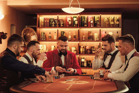 Group of upper class men playing poker in gentlemens clubの写真素材