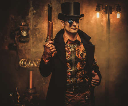 Steampunk man with gun on vintage steampunk backgroundの写真素材