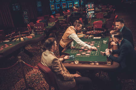Upper class friends gambling in a casinoの写真素材