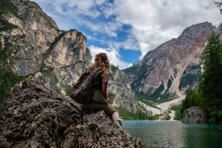 Beautiful woman hiker near wild mountain lakeの写真素材