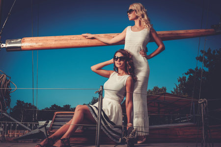 Stylish wealthy women on a luxury yachtの写真素材