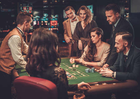 Upper class friends gambling in a casino