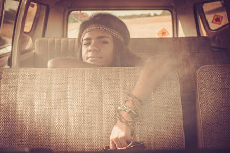Young black hippie woman in a retro vanの写真素材