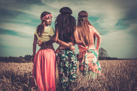 Multi-ethnic hippie girls in a wheat field