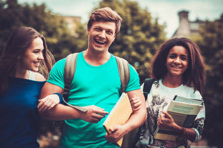 Group of multi ethnic students walking in a cityの写真素材