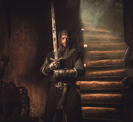Medieval knight in ancient castle interior.