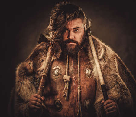Viking with axes in a traditional warrior clothesの写真素材