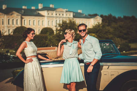 Wealthy friends near classic convertibleの写真素材