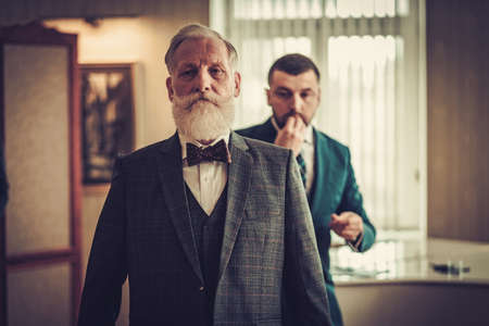 Tailor measuring client for custom made garmentの写真素材