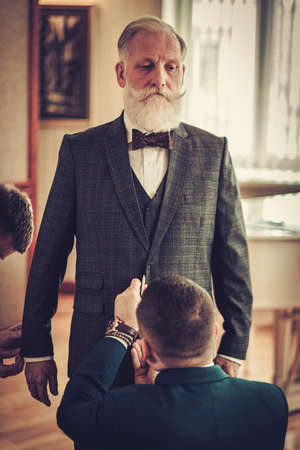 Tailor measuring client for custom made garmentの写真素材