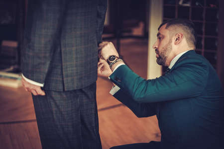 Tailor measuring client for custom made garmentの写真素材