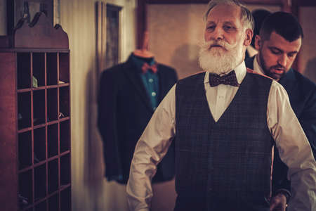 Tailor and his senior clinet in a workshopの写真素材