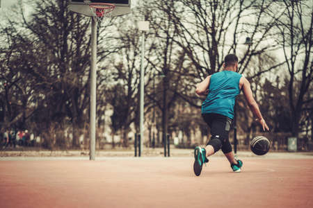 African-american streetball player practicing outdoors.の写真素材