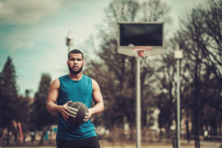 African-american streetball player practicing outdoorsの写真素材