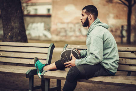African-american streetball player resting outdoorsの写真素材