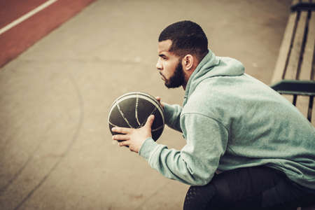 African-american streetball player resting outdoorsの写真素材