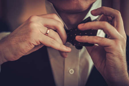 Man tying custom made bowtieの写真素材