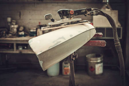 Classic car bodykit parts in painting workshopの写真素材