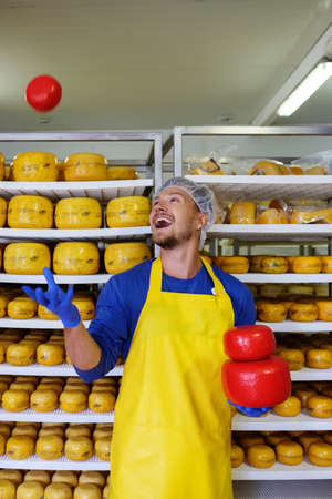 Handsome cheesemaker having fun in his workshop storage.