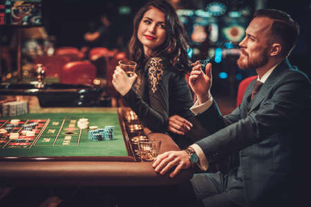 Upper class couple gambling in a casinoの写真素材