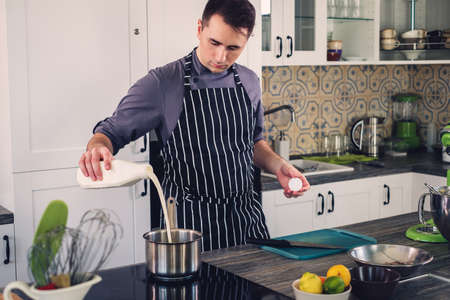 Chef cook working on a modern kitchen at homeの写真素材