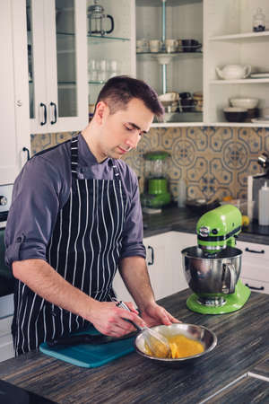 Chef cook working on a modern kitchen at homeの写真素材