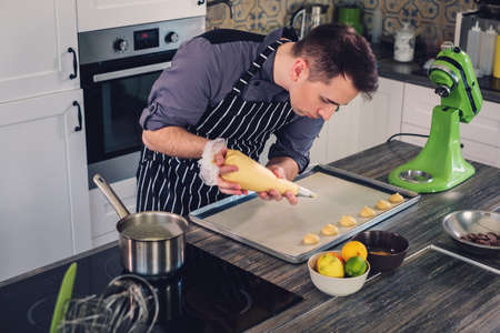 Chef cook working on a modern kitchen at homeの写真素材