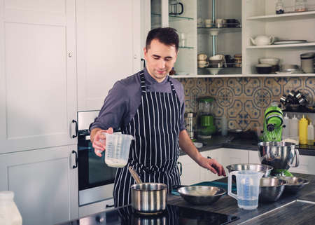 Chef cook working on a modern kitchen at homeの写真素材