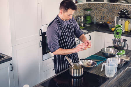 Chef cook working on a modern kitchen at homeの写真素材