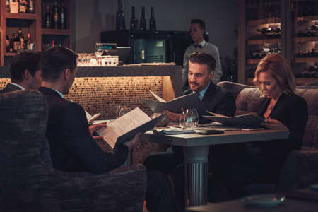 Friends rading menu in a restaurant.の写真素材