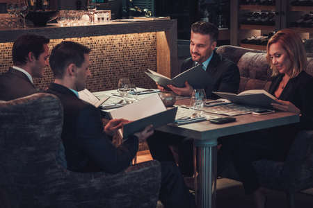 Friends rading menu in a restaurant.