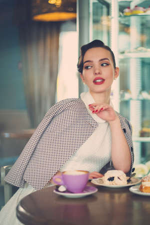 Elegant young lady alone in a cafeの写真素材