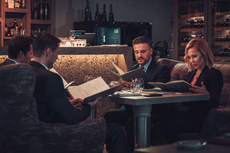 Friends rading menu in a restaurant.の写真素材