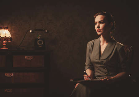 Beautiful woman composing letter in retro interior