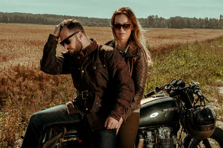 Couple and cafe racer motorcycleの写真素材