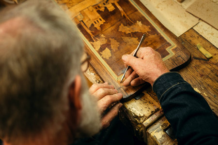 Senior wood carving professional during workの写真素材