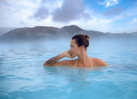 Woman enjoys spa in geothermal hot springの写真素材