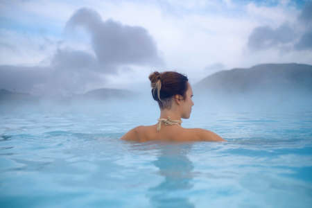 Woman enjoys spa in geothermal hot springの写真素材