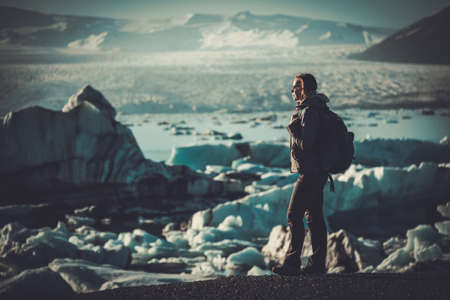 Woman explorer lookig at Jokulsarlon lagoon, Iceland.の写真素材