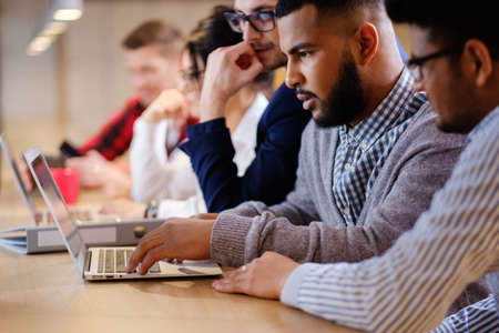 Young colleagues discussing ideas in coworking office.の写真素材