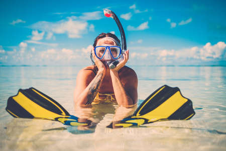 Snorkeler woman having fun on the tropical beach.の写真素材