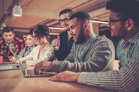 Young colleagues discussing ideas in coworking office.の写真素材
