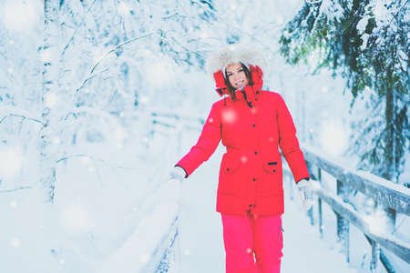 Happy woman in a snow landscape.の写真素材