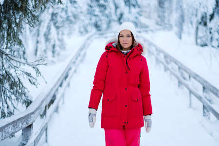 Happy woman in a snow landscape.の写真素材