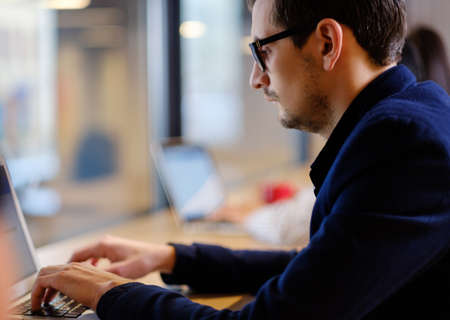 Young specialist in coworking office.の写真素材