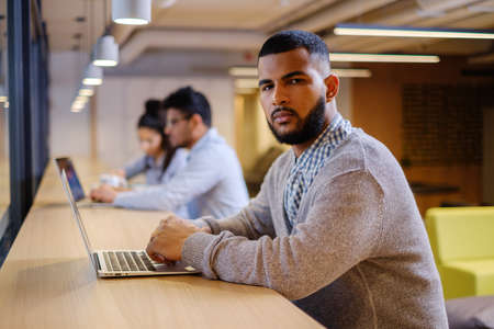 Young specialists in coworking office.